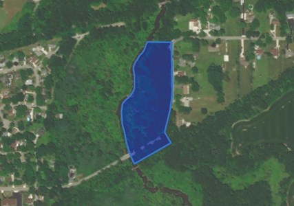 A wooded bordering the east side of Salt Creek